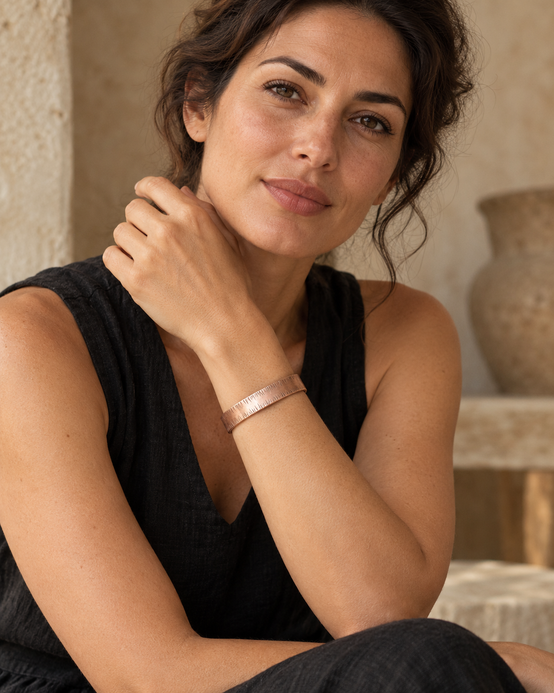 Female model wearing the textured copper cuff with black linen