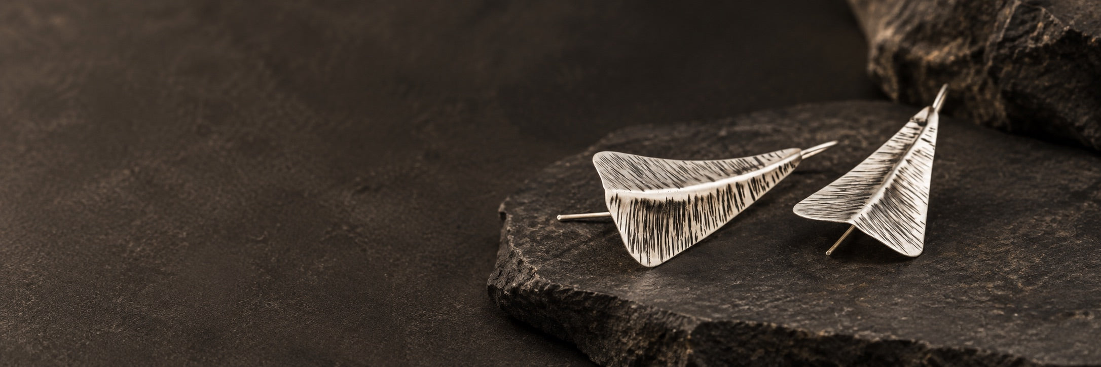 Folded silver leaf earrings with an oxidized etched texture